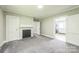 Bedroom showcasing neutral walls, carpet, and decorative fireplace with view of the kitchen at 807 3Rd St, Kings Mountain, NC 28086