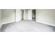 Carpeted room with doorways, showing the layout and flow of the living space at 807 3Rd St, Kings Mountain, NC 28086