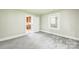 This is a bedroom with neutral walls and carpet, adjacent to the kitchen, offering comfortable living space at 807 3Rd St, Kings Mountain, NC 28086