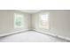 Bright bedroom with neutral walls and carpet, featuring two windows for ample natural light at 807 3Rd St, Kings Mountain, NC 28086