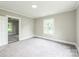 Bright bedroom with neutral carpet, featuring a window and doorway for ample light and access at 807 3Rd St, Kings Mountain, NC 28086