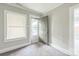 Bedroom featuring neutral carpet, a window with blinds, and an exterior door at 807 3Rd St, Kings Mountain, NC 28086