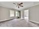 Carpeted bedroom with neutral tones, highlighting the ceiling fan and doorways leading to other rooms at 807 3Rd St, Kings Mountain, NC 28086