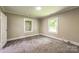 This bedroom offers natural light from two windows and neutral walls and carpet at 807 3Rd St, Kings Mountain, NC 28086