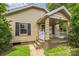 Charming single-story home featuring a covered front porch with decorative white picket fence at 807 3Rd St, Kings Mountain, NC 28086