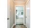 Hallway with tile flooring leading to a bright, open room, showcasing the home's layout at 807 3Rd St, Kings Mountain, NC 28086