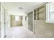 Enclosed sunroom featuring shelving and windows, offering plenty of natural light and additional space at 807 3Rd St, Kings Mountain, NC 28086