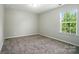 Cozy bedroom with carpeting and a bright window at 8115 Kelburn Ln, Charlotte, NC 28273