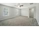 Spacious bedroom with plush carpeting, two windows for ample natural light, and a ceiling fan at 8115 Kelburn Ln, Charlotte, NC 28273
