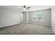 Bedroom with plush carpeting, ceiling fan, and good natural light at 8115 Kelburn Ln, Charlotte, NC 28273