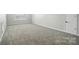 Large empty bedroom with neutral carpeting and a window; perfect for customization at 8115 Kelburn Ln, Charlotte, NC 28273