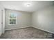 Bright bedroom featuring plush carpeting, a window with natural light and neutral-colored walls at 8115 Kelburn Ln, Charlotte, NC 28273