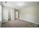 Bedroom features carpeting, an open door, and natural lighting at 8115 Kelburn Ln, Charlotte, NC 28273