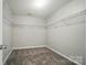 Walk-in closet with carpeted flooring and wire shelving for optimal storage at 8115 Kelburn Ln, Charlotte, NC 28273