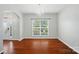 Bright dining room featuring hardwood floors, a chandelier, and a large window overlooking the yard at 8115 Kelburn Ln, Charlotte, NC 28273