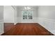 Charming dining room featuring hardwood floors, decorative wainscoting, and a chandelier at 8115 Kelburn Ln, Charlotte, NC 28273