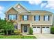 Charming two-story home featuring brick and siding exterior, blue shutters, and a two-car garage at 8115 Kelburn Ln, Charlotte, NC 28273