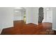 Spacious living area with hardwood floors, arched doorways, and neutral paint at 8115 Kelburn Ln, Charlotte, NC 28273