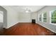Bright living room features a fireplace, hardwood floors, and ample natural light at 8115 Kelburn Ln, Charlotte, NC 28273