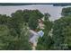 Aerial view of the property with a pool, dock, and lush surrounding trees at 8593 Bailey Dr, Terrell, NC 28682