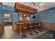 Basement bar with rich wood detailing, overhead lighting, and seating, creating an inviting entertainment space at 8593 Bailey Dr, Terrell, NC 28682