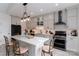 Well-lit kitchen boasts a central island with seating, sleek appliances, and contemporary design elements at 8593 Bailey Dr, Terrell, NC 28682