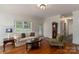 Comfortable living room featuring hardwood floors, a neutral sofa, and plenty of natural light at 8593 Bailey Dr, Terrell, NC 28682