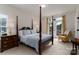Serene main bedroom features a four-poster bed and private access to the outdoor area at 8593 Bailey Dr, Terrell, NC 28682