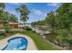 Inviting backyard with a swimming pool and covered patio overlooking the serene waterfront at 8593 Bailey Dr, Terrell, NC 28682