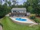 This backyard boasts a large inground pool, deck, and beautiful landscaping for outdoor living at 8593 Bailey Dr, Terrell, NC 28682