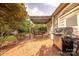 Backyard patio featuring a pergola, outdoor seating, and a stainless steel grill at 901 Clearbrook Rd, Matthews, NC 28105