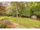 Expansive backyard with mature trees and shed at 901 Clearbrook Rd, Matthews, NC 28105