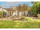 Backyard featuring a stone patio, manicured lawn, and mature landscaping at 901 Clearbrook Rd, Matthews, NC 28105