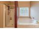 Bright bathroom featuring separate shower and a large soaking tub at 901 Clearbrook Rd, Matthews, NC 28105