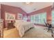 Comfortable bedroom with a vaulted ceiling, a large window, and a dedicated desk area at 901 Clearbrook Rd, Matthews, NC 28105