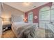 Inviting bedroom featuring arched windows, plush bedding, and neutral tones at 901 Clearbrook Rd, Matthews, NC 28105