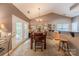 Well-lit dining room with a wooden table, seating for six, and access to the outdoor patio at 901 Clearbrook Rd, Matthews, NC 28105