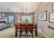 Cozy dining area, with view to fireplace and outdoor seating, features wooden table and seating for six at 901 Clearbrook Rd, Matthews, NC 28105