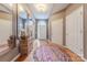 Bright foyer with hardwood floors and natural light features storage furniture and large mirrors at 901 Clearbrook Rd, Matthews, NC 28105