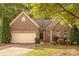 Charming brick home with manicured lawn and attached garage, offering classic curb appeal at 901 Clearbrook Rd, Matthews, NC 28105