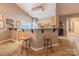 Open kitchen with a breakfast bar, wood cabinets, and modern appliances, ideal for casual dining at 901 Clearbrook Rd, Matthews, NC 28105