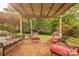 Brick patio with a pergola, multiple seating areas, and lush greenery at 901 Clearbrook Rd, Matthews, NC 28105