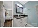 Well-lit bathroom featuring a vanity with granite countertops and modern fixtures, adjacent to the main bedroom at 926 Meadow Lakes Rd, Rock Hill, SC 29732