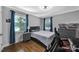 Comfortable bedroom with hardwood floors, a desk, and two large windows offering natural light at 926 Meadow Lakes Rd, Rock Hill, SC 29732