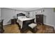 Bedroom with hardwood floors, a dark wood sleigh bed, and matching dressers at 926 Meadow Lakes Rd, Rock Hill, SC 29732