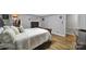 Cozy bedroom featuring hardwood floors, neutral walls, and a view into a large walk-in closet at 926 Meadow Lakes Rd, Rock Hill, SC 29732