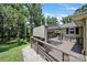 A spacious outdoor deck with seating, shade, and lush green foliage at 926 Meadow Lakes Rd, Rock Hill, SC 29732