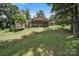Exterior view of a home with a spacious backyard, deck, and plenty of mature trees at 926 Meadow Lakes Rd, Rock Hill, SC 29732