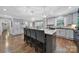 Spacious kitchen with hardwood floors, stainless steel appliances, granite countertops, and modern lighting fixtures at 926 Meadow Lakes Rd, Rock Hill, SC 29732
