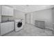Laundry room featuring gray cabinets, appliances, and stylish tiled floor at 926 Meadow Lakes Rd, Rock Hill, SC 29732